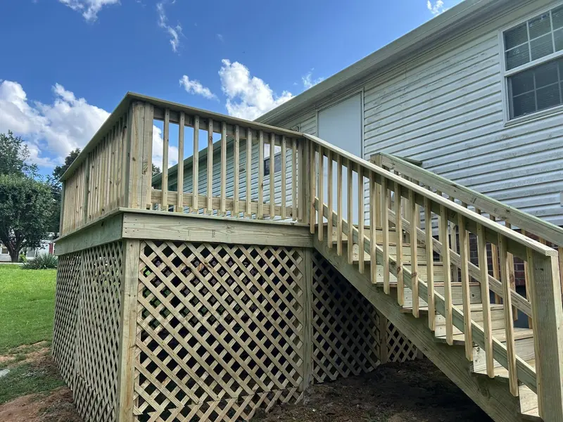 Treated-lumber deck with railing, stairs and lattice skirting
