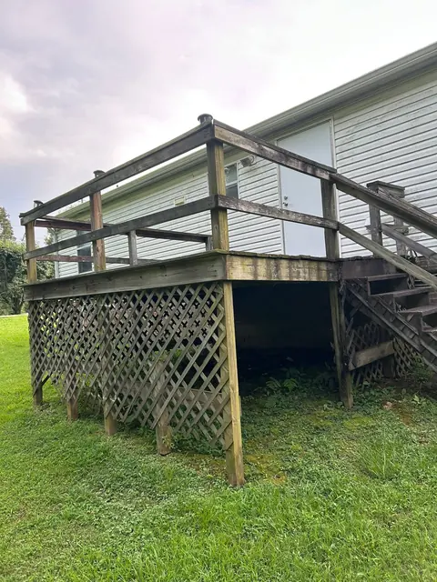 Weathered older deck with worn railing and lattice
