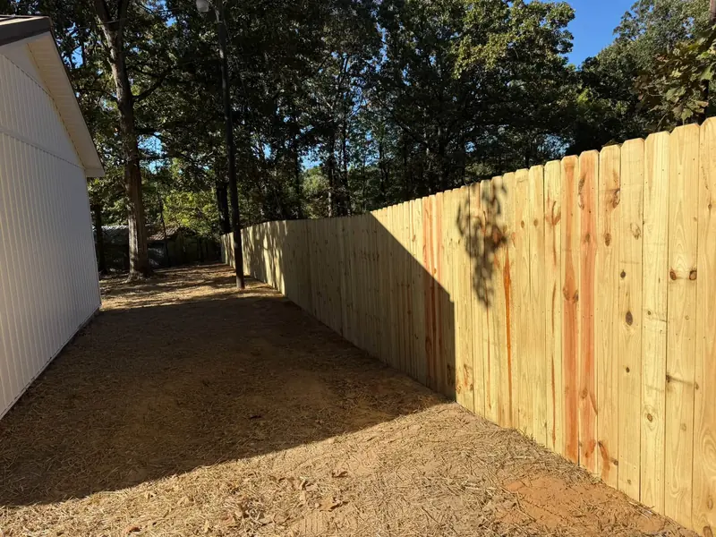 New wood privacy fence beside a building