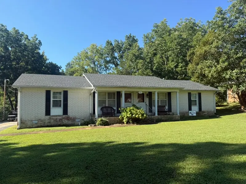 Brick home with gray shingle roof