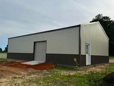 Metal pole shop with a roll-up overhead door and a walk door