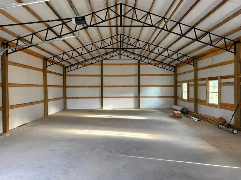 Inside a pole shop: steel trusses and concrete floor